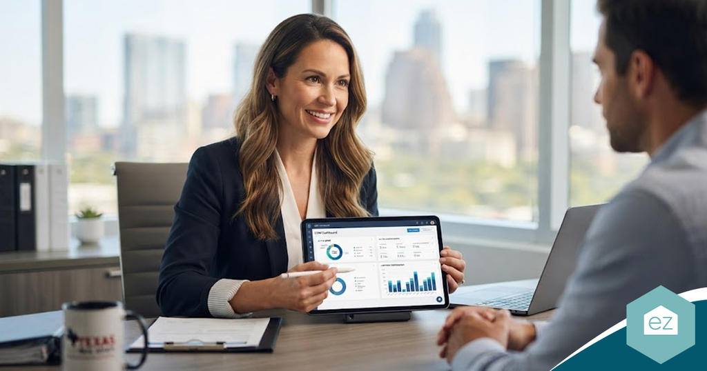 A woman in a blazer shows Texas real estate leads on a tablet dashboard during a meeting with a man in an office.