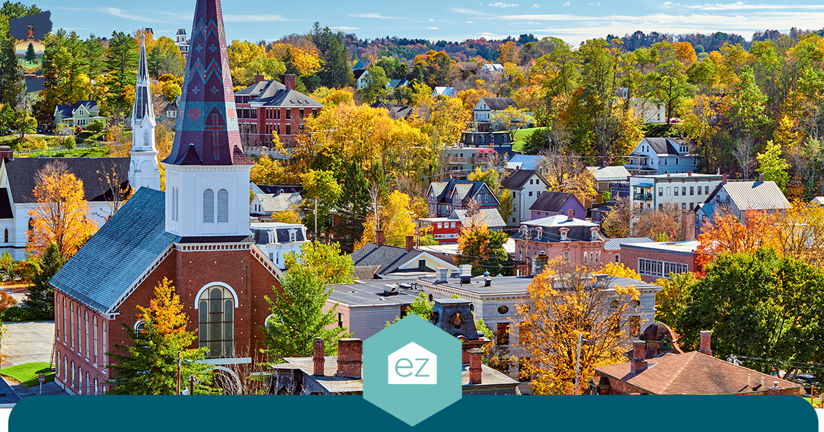 Vermont small town with autumn trees, historic brick buildings, and a tall church steeple