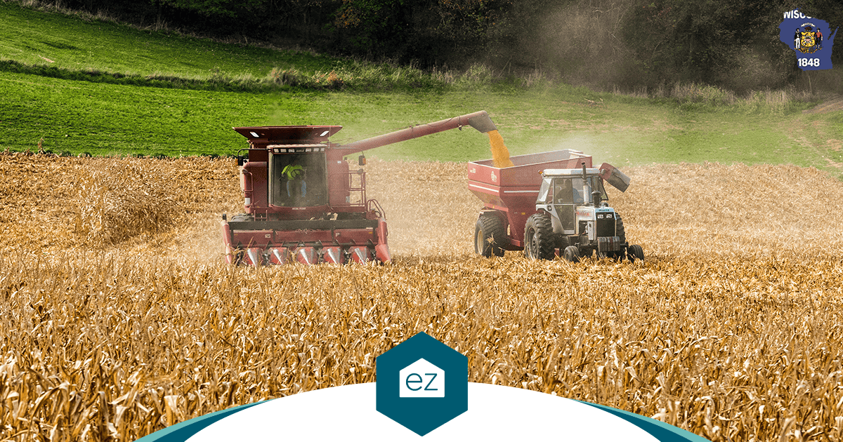 A combine harvester unloading corn into a trailer in a Wisconsin field at harvest